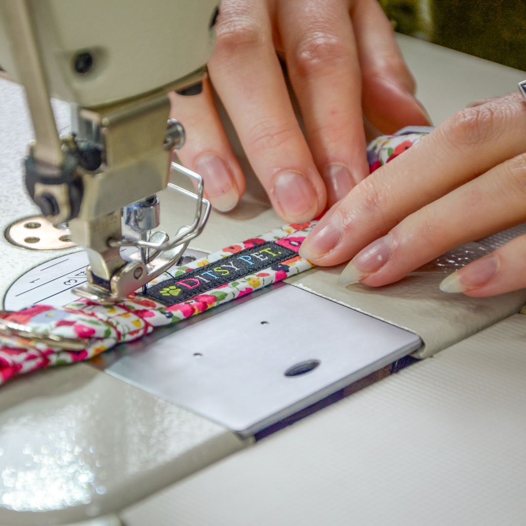 Ditsy Pet | Picture of hands sewing a collar